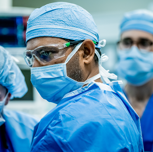 Physicians in the operating room preparing for heart surgery.