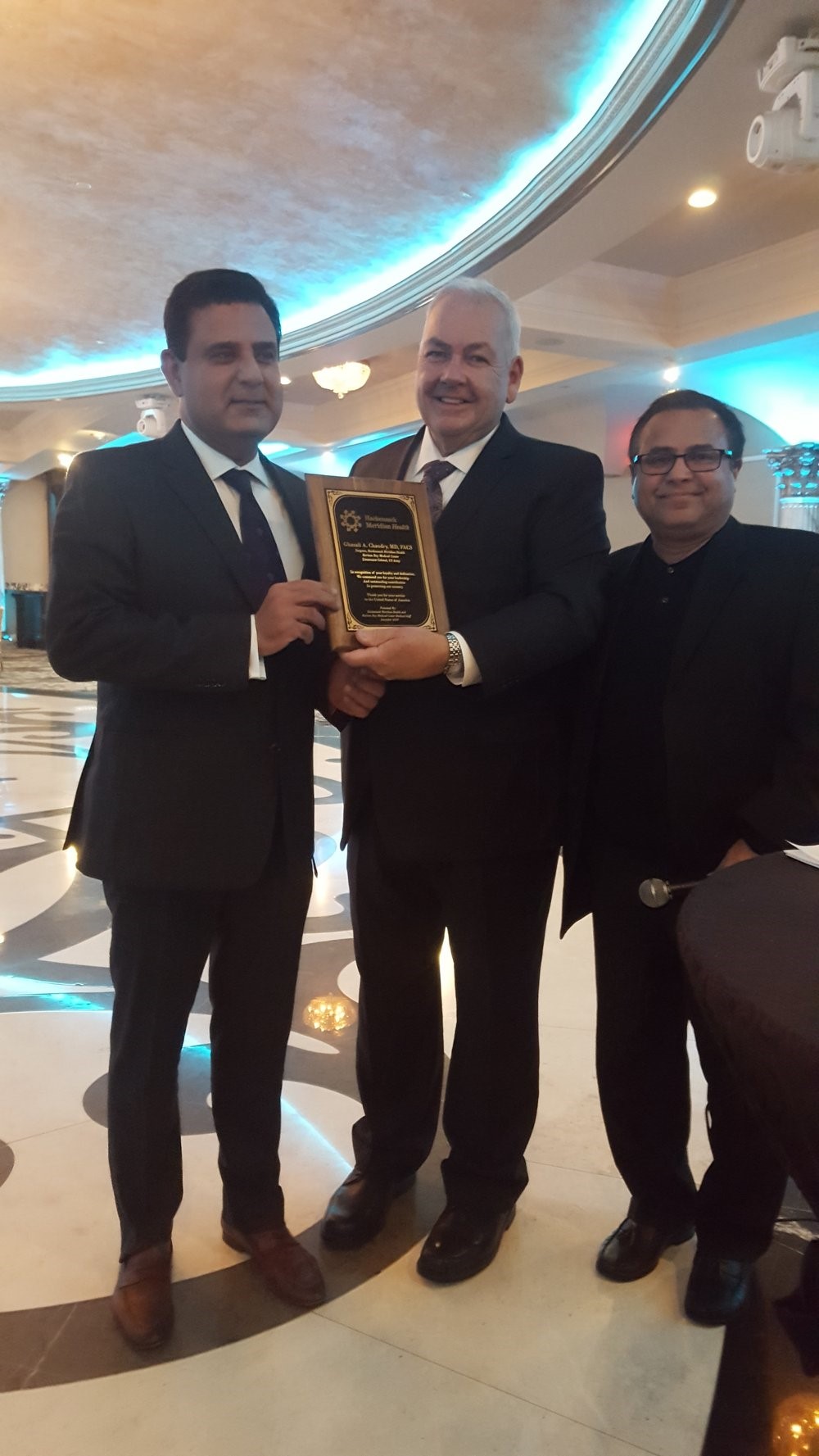 Ghazali Chaudry, M.D.,FACS (left) receiving his award for service to the country and Raritan Bay Medical Center
